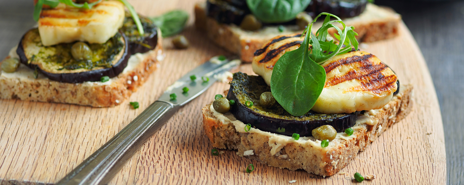 Photo of - Roasted Vegetable Tartine with Arugula Pesto and Grilled Halloumi